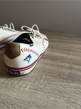 Keds Men's White Canvas Lace-Up Sneakers with Red Stitch Detail/Blue Jays Logo